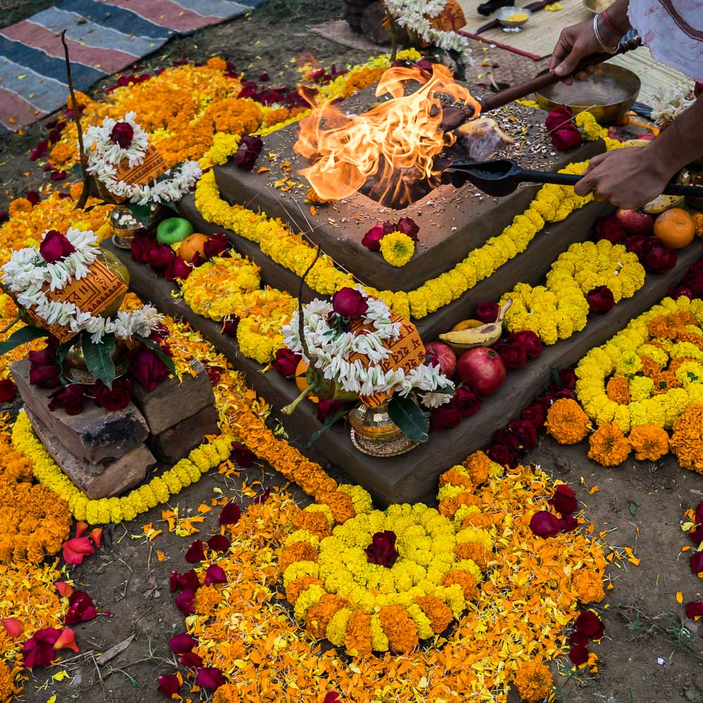 Hindu yagya altar decorated with flowers and sacred fire offerings